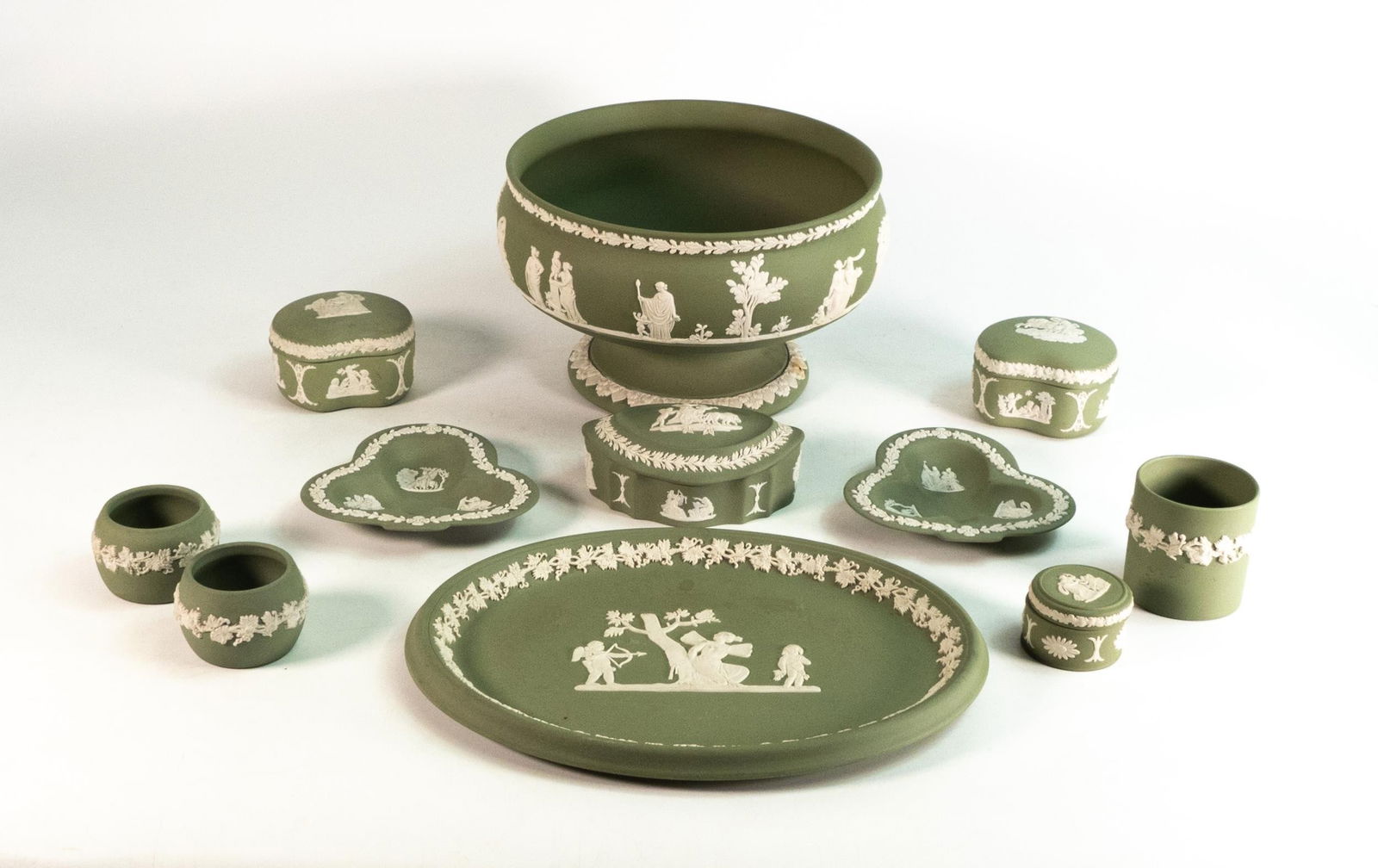 A collection of Wedgwood Sage green Jasperware items to include a fruit bowl, tray, three trinket: A collection of Wedgwood Sage green Jasperware items to include a fruit bowl, tray, three trinket pots, pill box, three small pots and two trinket dishes (11)