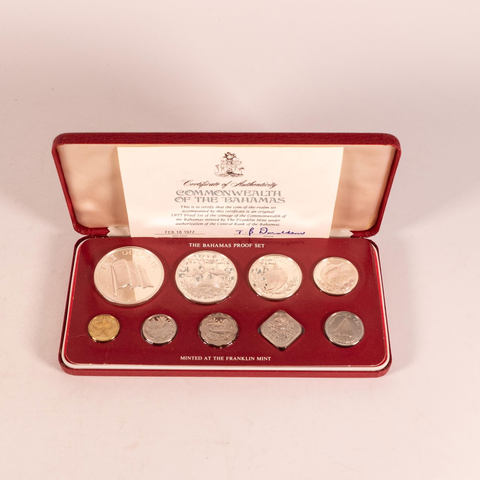The Franklin Mint, 1977 Bahamas nine-coin proof set, in leather presentation box with paperwork. (1 of 2)