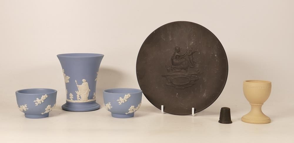 Wedgwood, Five items of Jasperware to include yellow eggcup, two blue prunus bowls and a small vase,: Wedgwood, Five items of Jasperware to include yellow eggcup, two blue prunus bowls and a small vase, black basalt thimble and small plate