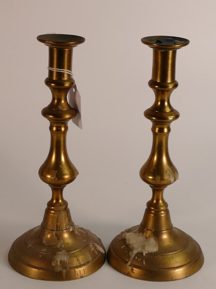 19th century circular base brass candlesticks, height 15cm, both push rods present: 19th century circular base brass candlesticks, height 15cm, both push rods present