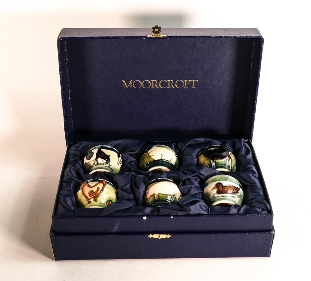 Boxed set of six Moorcroft egg cups decorated with a farm scene designed by Anji Davenport. Height: Boxed set of six Moorcroft egg cups decorated with a farm scene designed by Anji Davenport. Height 4.5cm.