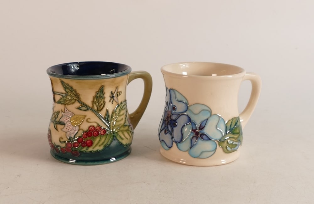 Two Moorcroft Mugs to include strawberries and wild berries together with blue pansies (crazed) (2): Two Moorcroft Mugs to include strawberries and wild berries together with blue pansies (crazed) (2)