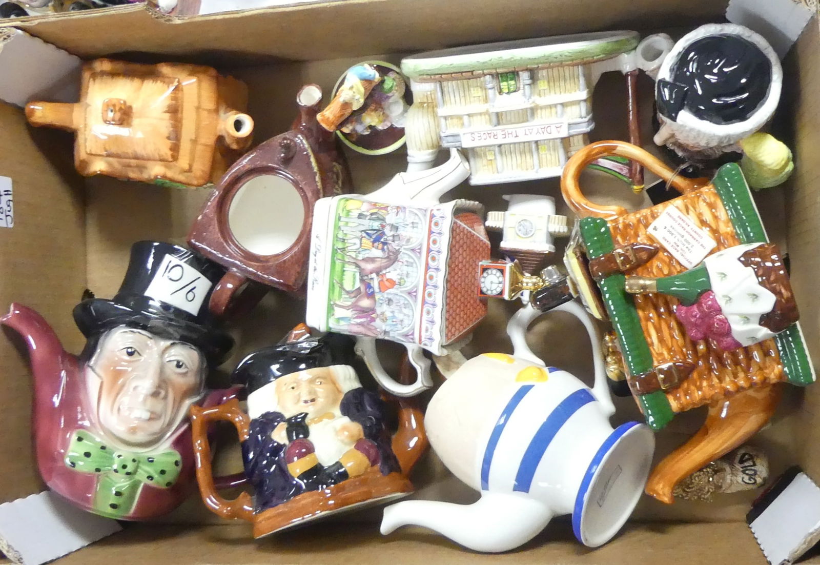 A Selection Of Various Decorative Teapots Including Royal Ascot Desk, Egg Cup With Egg & Toast, A: A Selection Of Various Decorative Teapots Including Royal Ascot Desk, Egg Cup With Egg & Toast, A Day At The Races (Two Types), Teddy Bears Lid On An Iron, The Mad Hatter , Thatched Cottage Etc(1T