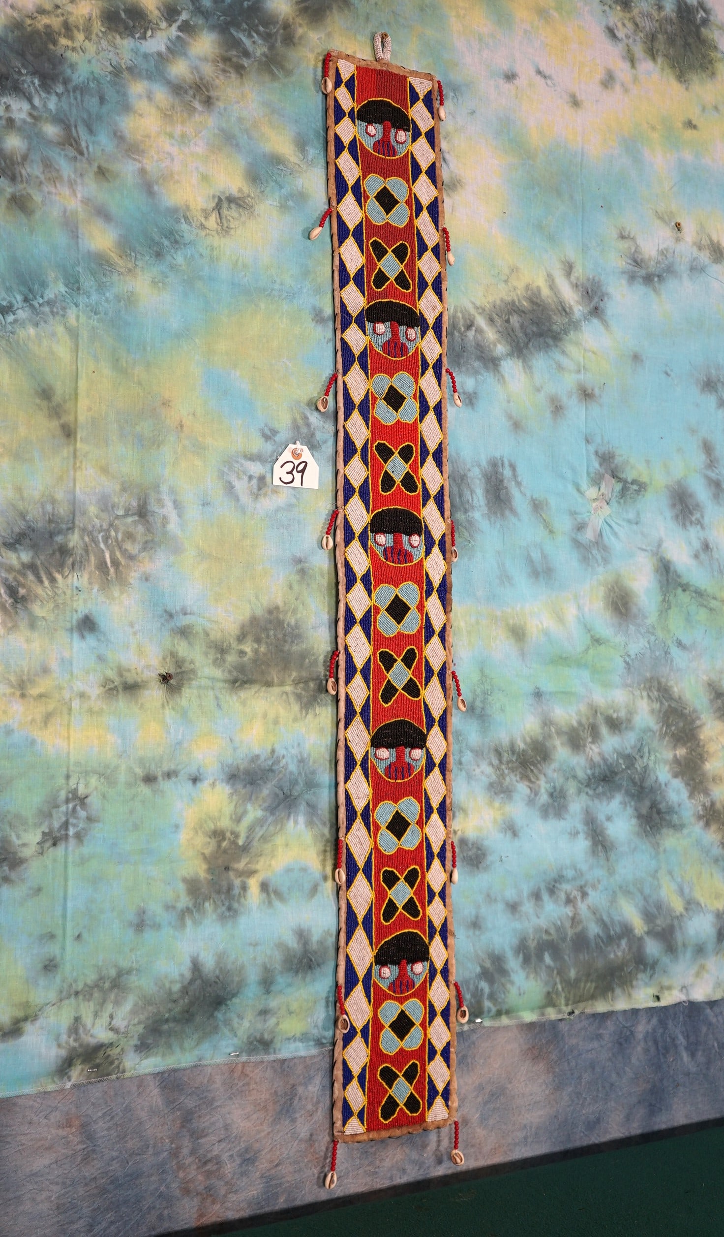 West African Wall Decoration: This pretty display was handmade from beads and small sea shells. This type of decoration comes from Liberia and the Ivory Coast.