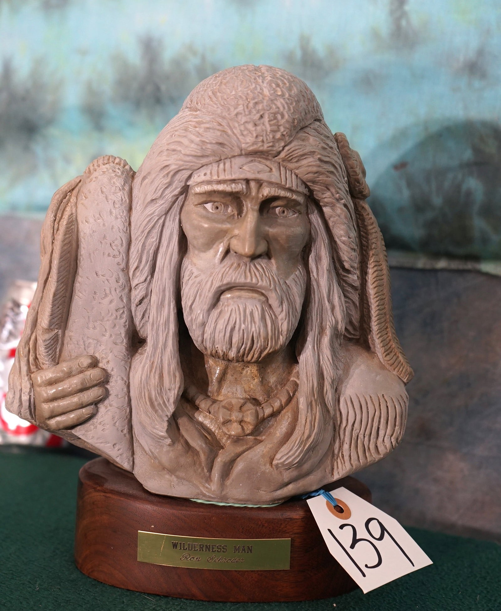 "Wilderness Man" Head & Shoulder Bust by Ron Schroder: This is a very well done Resin Carving on an oval Walnut Pedestal. It measures 10 3/4" high and 8 1/2" wide.