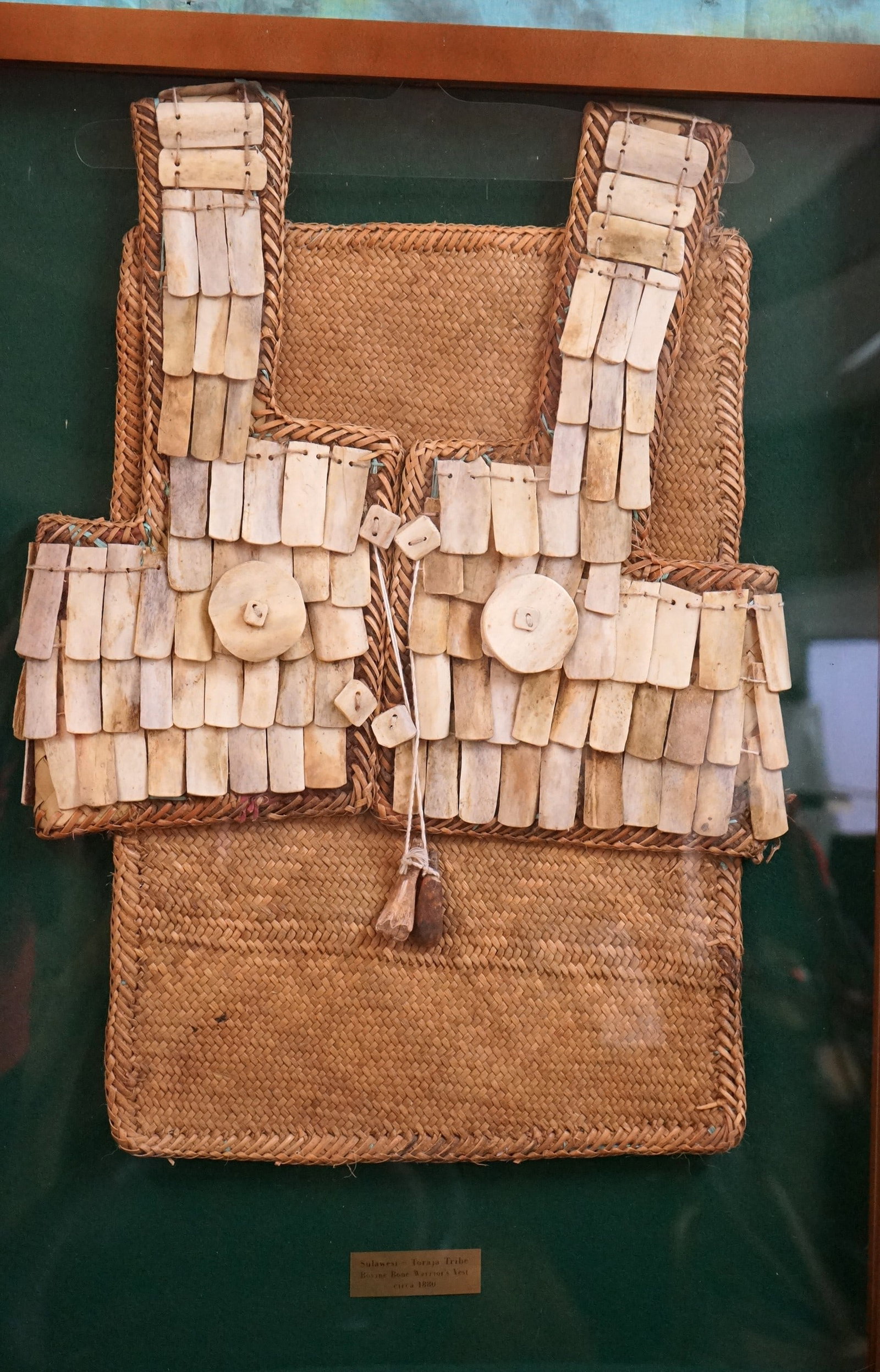 1880 circa Framed Indonesian Bovine Bone Warriors Vest: This Vest is authentic and in excellent condition, very nicely displayed in a high quality case.