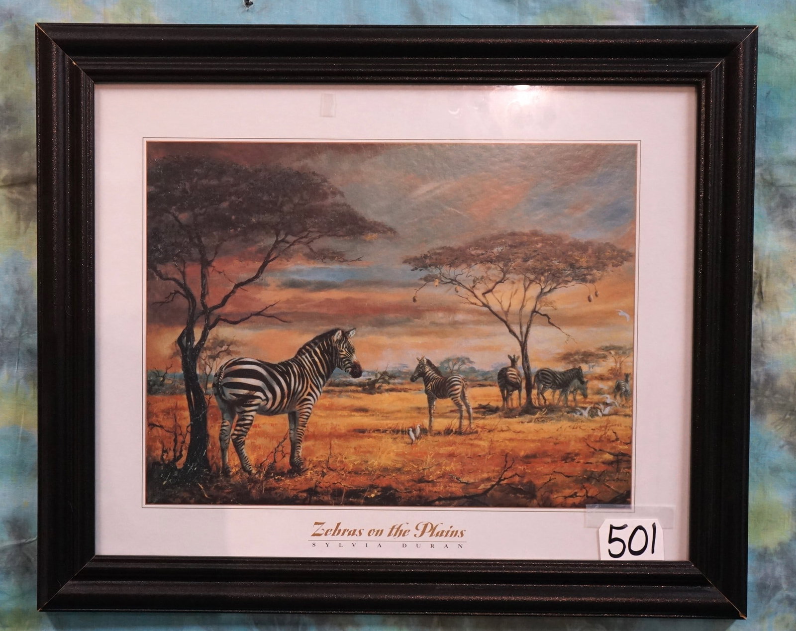 Very Nice Framed Print called "Zebras on the Plains", by Sylvia Duran: This is a very nice eye catching Print of the African plains. The frame is of good quality measuring 23 1/2" x 19 1/2". This is a colorful Print with a good quality hanger.