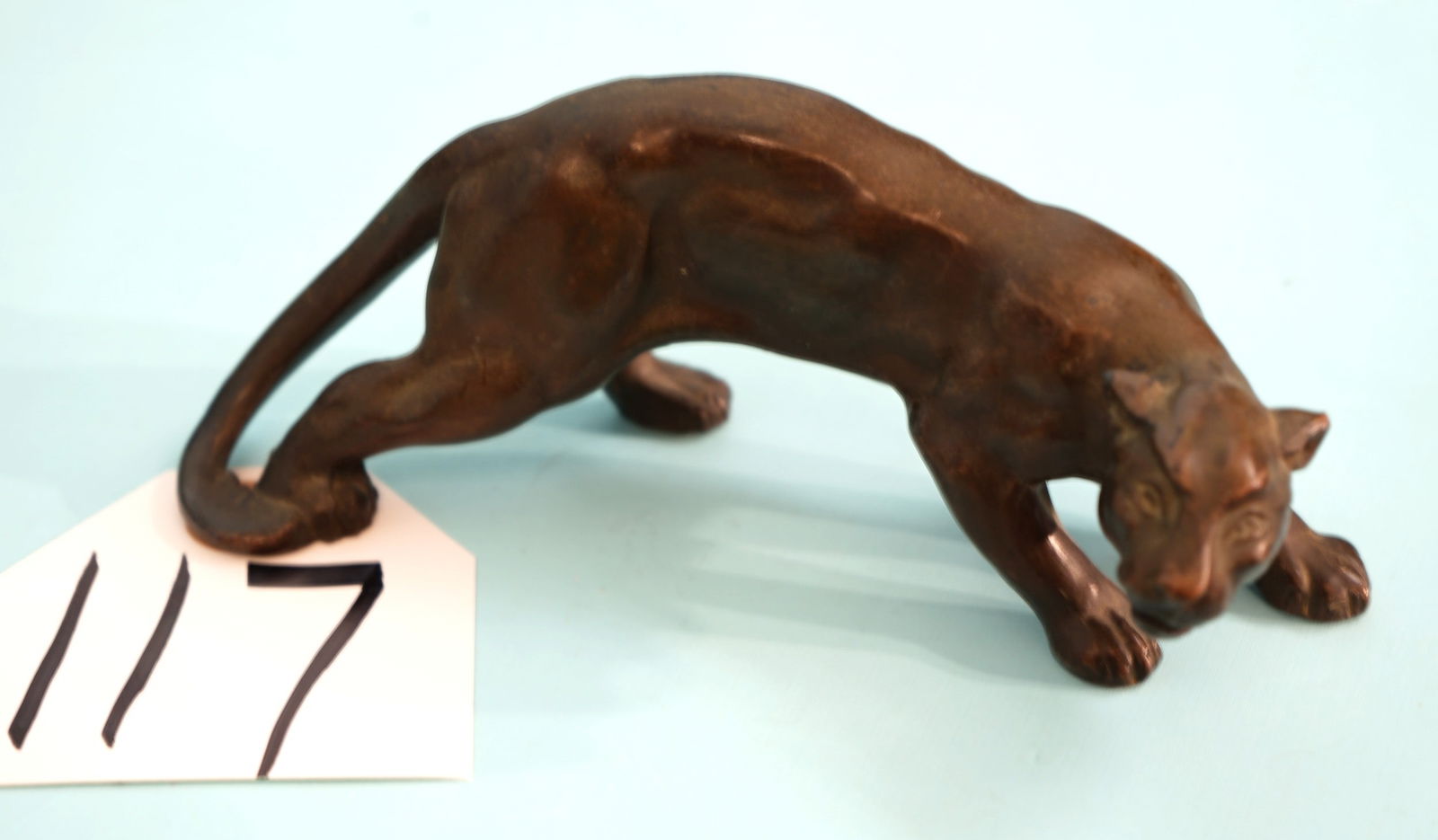 Cool! Solid Bronze Mountain Lion Decoration For Cabin Decor: This bronze is solid, and approximately 6" long, and 2" wide. The Paws are flat on the bottoms, and this Bronze will sit nicely on a shelf or coffee table.