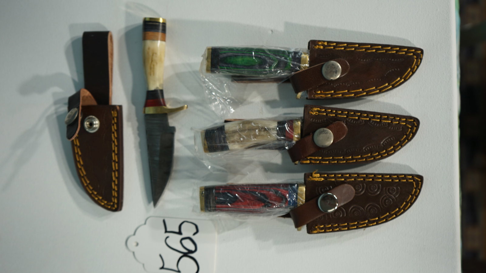 Four Brand New Knives with Sheaths: These Knives are all the same size and new. They make good skinning knives and they will hold a sharp edge.