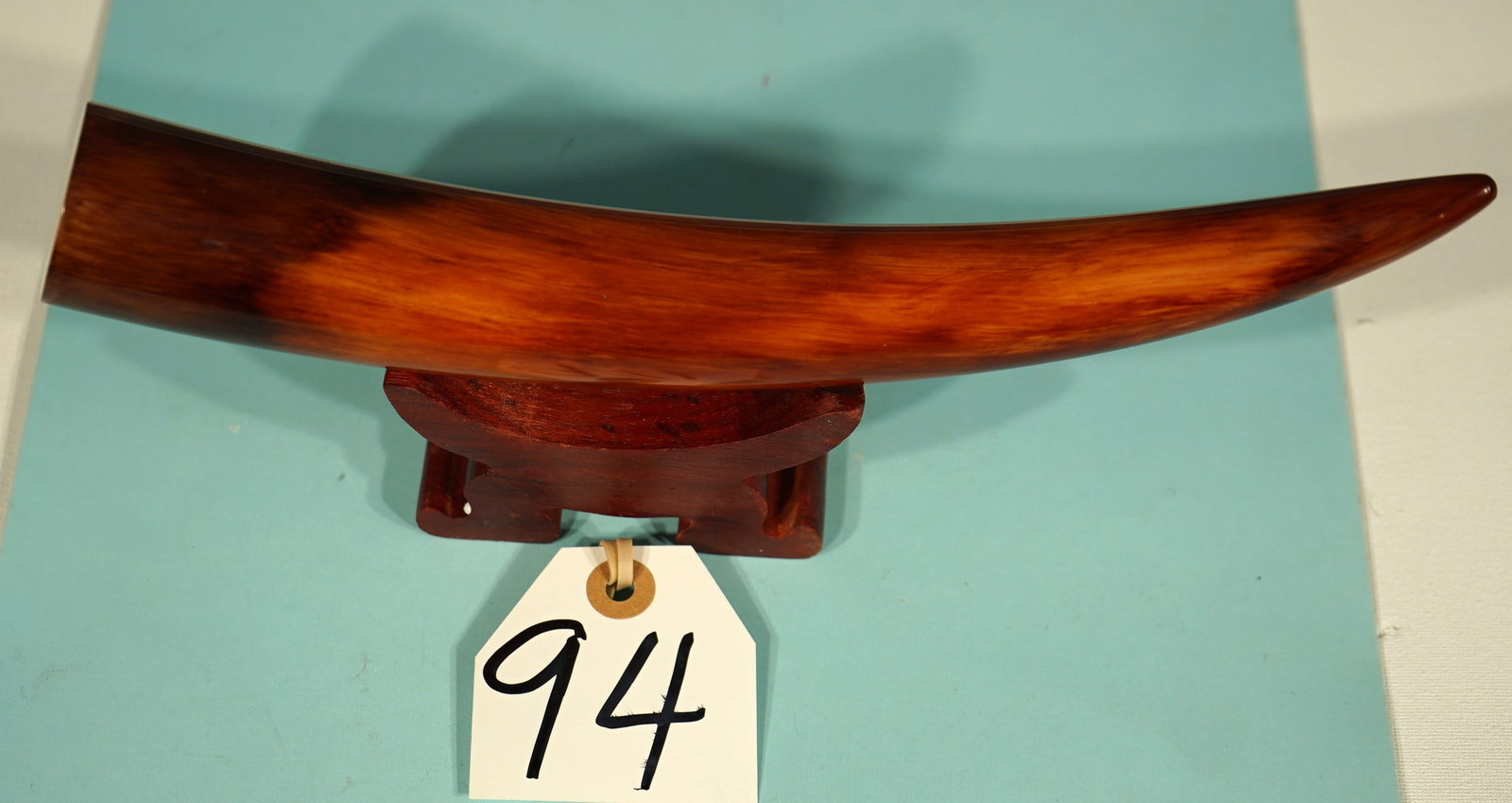 Authentic Juvenile Mammoth Tusk Tip on Display Stand: This beautiful Tusk Tip measures a little over one foot long at 12 3/8". It was cut off about half way, because the back end was exposed from the tundra, and the constant wet weather had began to caus