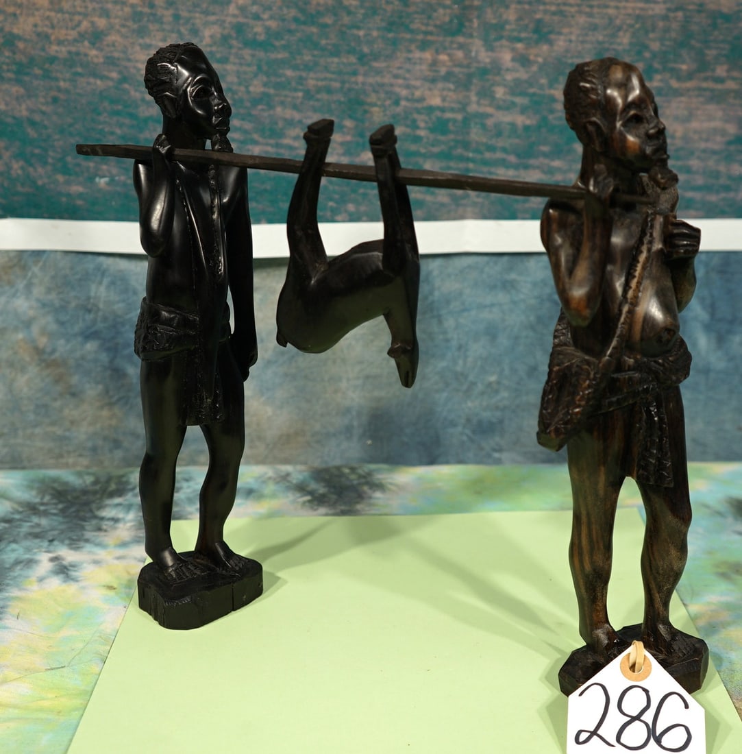 Hand Carved Ironstone Wood African Hunters Carrying a Antelope: These two Hunters from Africa with their Harvest is great for a Coffee Table or a fireplace lodge, and it makes a great decor for a trophy room.