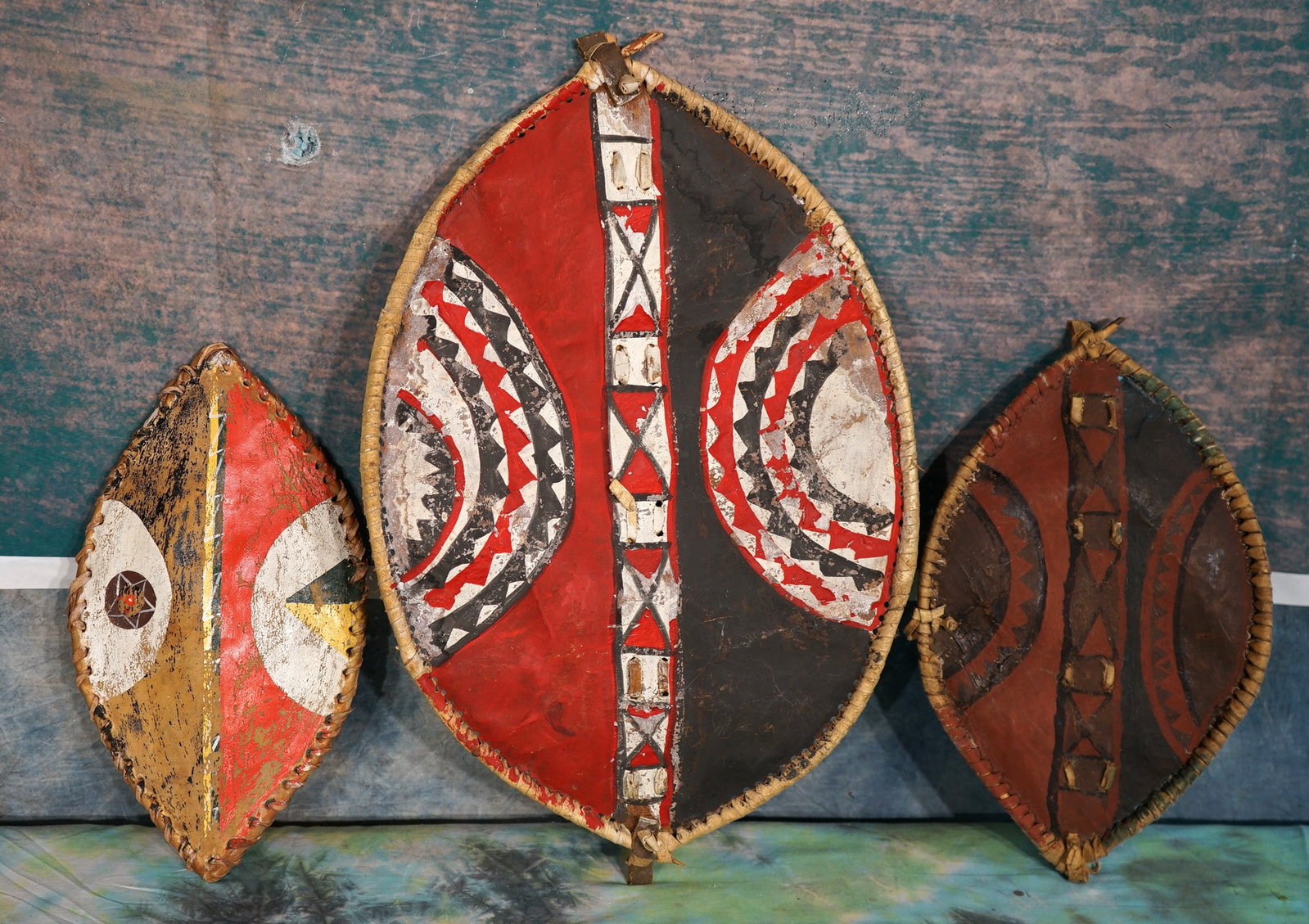 Three Authentic Masai Children's Handmade Shields: These are Shields made from animal skins and hand painted. This type is well used to place on the wall for decor.