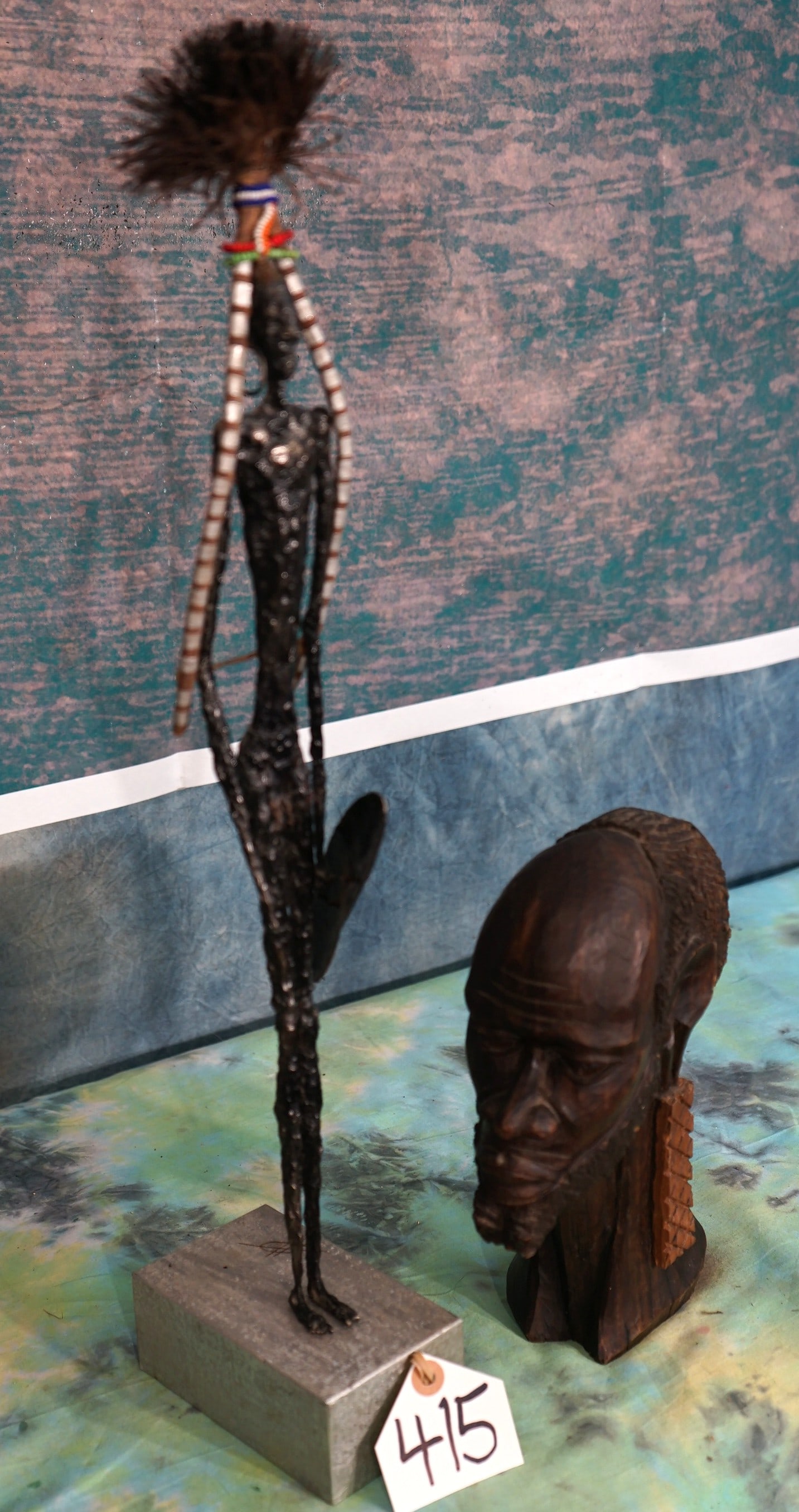 Pair of Handmade African Statues: Here we have an African Man head bust that has been hand carved, and also a very tall Masai Warrior made from a metal and tin. Both are East African Masai Decor.