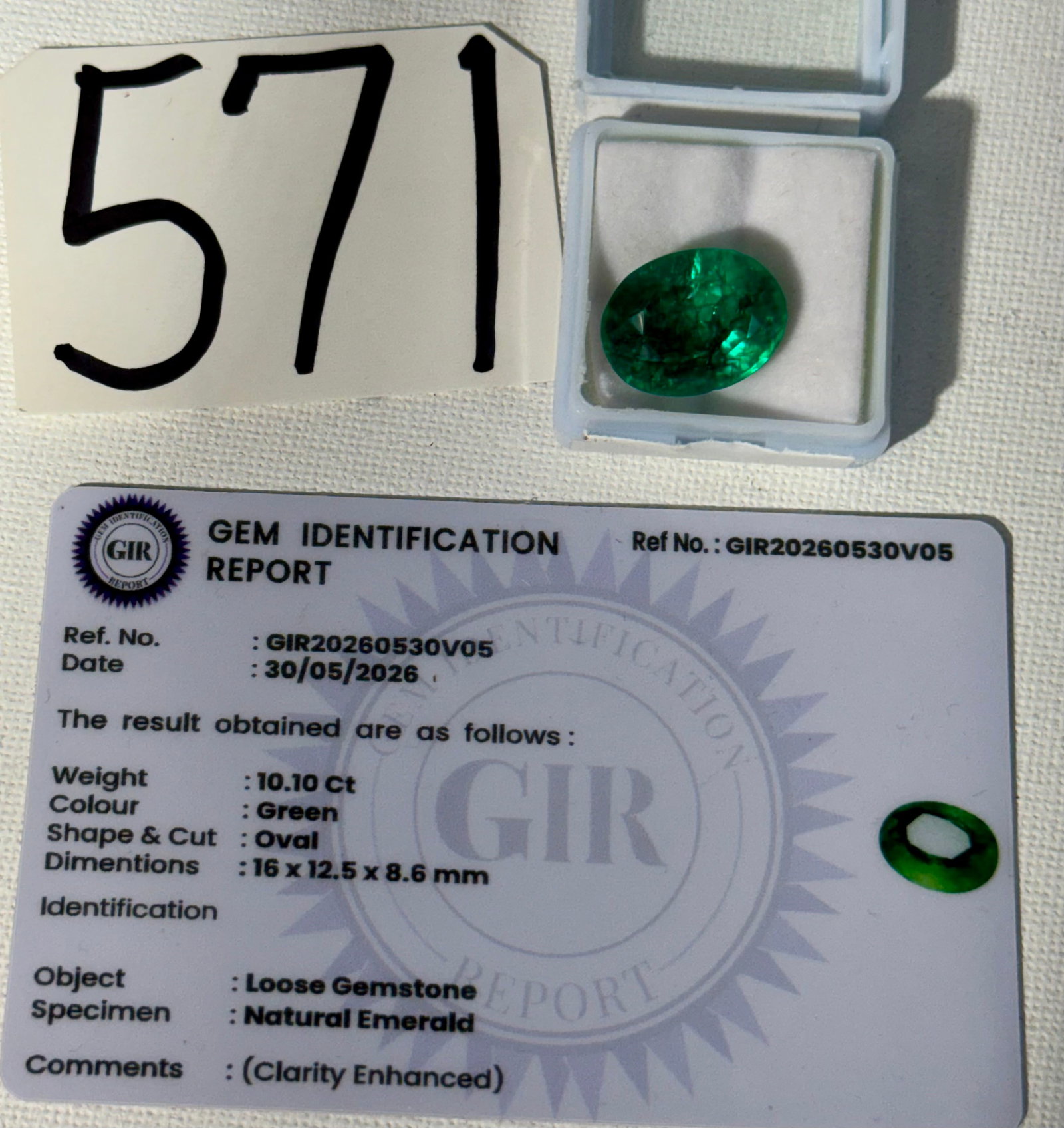 Beautiful Good Quality 10.10Ct. Oval Cut Emerald with Gemstone Identification Report Card: This pretty oval cut Emerald is perfect for a pendant, or a large ring. Any certified jeweler can set this in a Gold or Silver Ring. It has a bright sparkle to it, and is partially translucent. This c