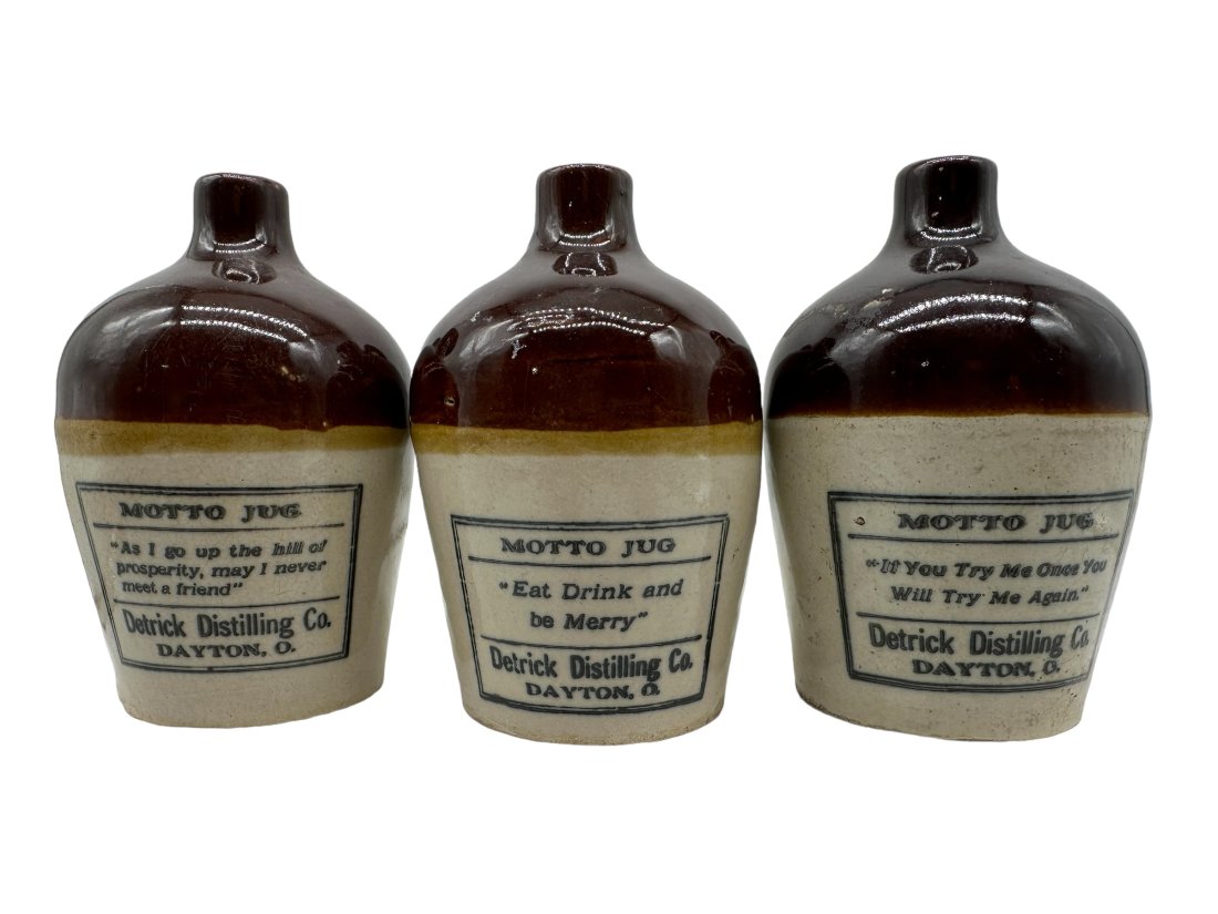 Lot Of 3 Derrick Distilling Co Dayton OH Motto Whiskey Jugs: All in good condition. Each measures 4.5 inches tall.