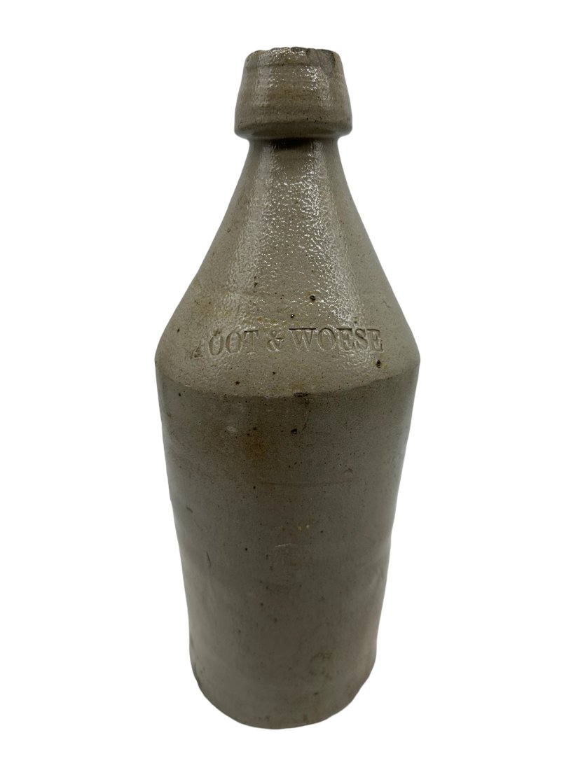 ?oot & Woese Tall Ironstone Bottle: May be stamped "FOOT & WOESE".Chips on lip. Measures 11 inches tall.