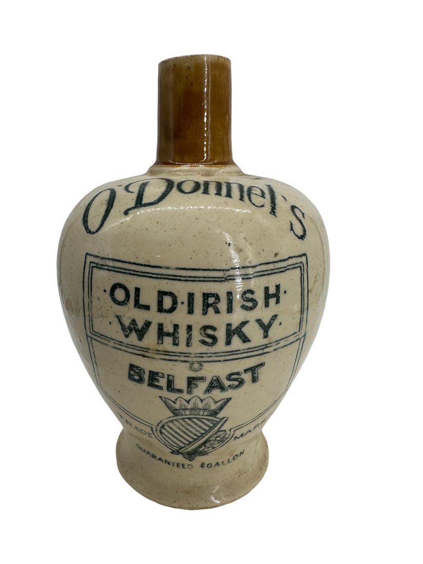 O'Donnel's Old Irish Whisky Belfast Stoneware: Chip on lip and bottom rim. 8 inches tall.