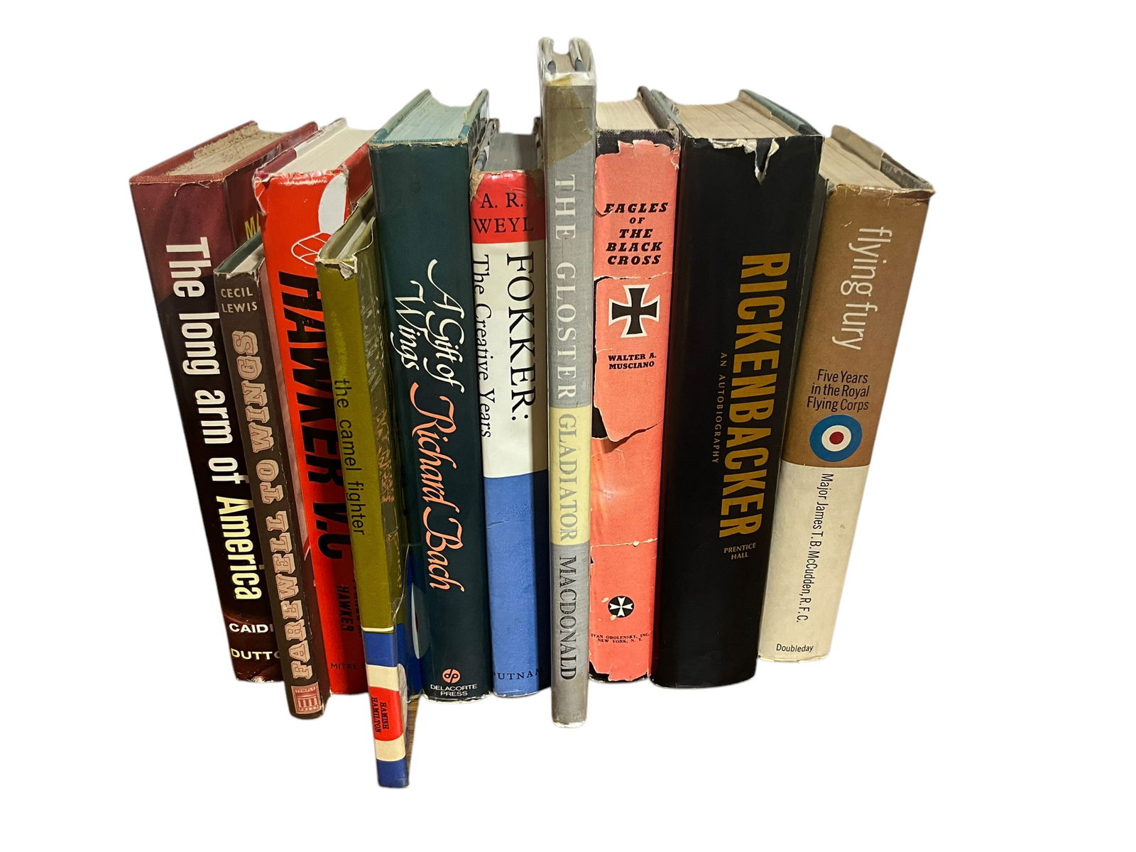 Set of 10 Books (Historical Aviation) Copyrights from 1960’s to 1970’s: Good Condition. Hard Backs. Includes the following titles:The Long Arm of America by Martin Caidin,Fairwell to Wings by Cecil Lewis,Hawker V.C. by Tyrrel M. Hawker,The Camel Fighter by John Pudney,A G