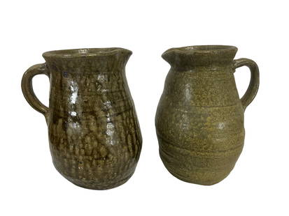 Two Grace Nell Hewell Pitchers: Both in mint condition. Both signed on bottom. One dated 5-19-2004, other dated 5-20-2004. Each stands 6.75 inches.