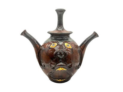 Roger Corn Double Spouted Face Teapot: Mint condition. Stands 12.5 inches tall with lid on. 14 inches wide from spout to spout. Signed and dated 2005 on bottom of
