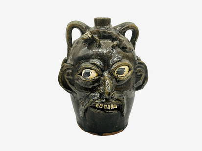 Early Chester Hewell Double Face Double Lizard Jug: A great double mustache face jug by Chester with an applied lizard on each forehead. Signed and dated 1988 on bottom. Stands 10 inches tall and approximately 7 inches wide from ear to ear.