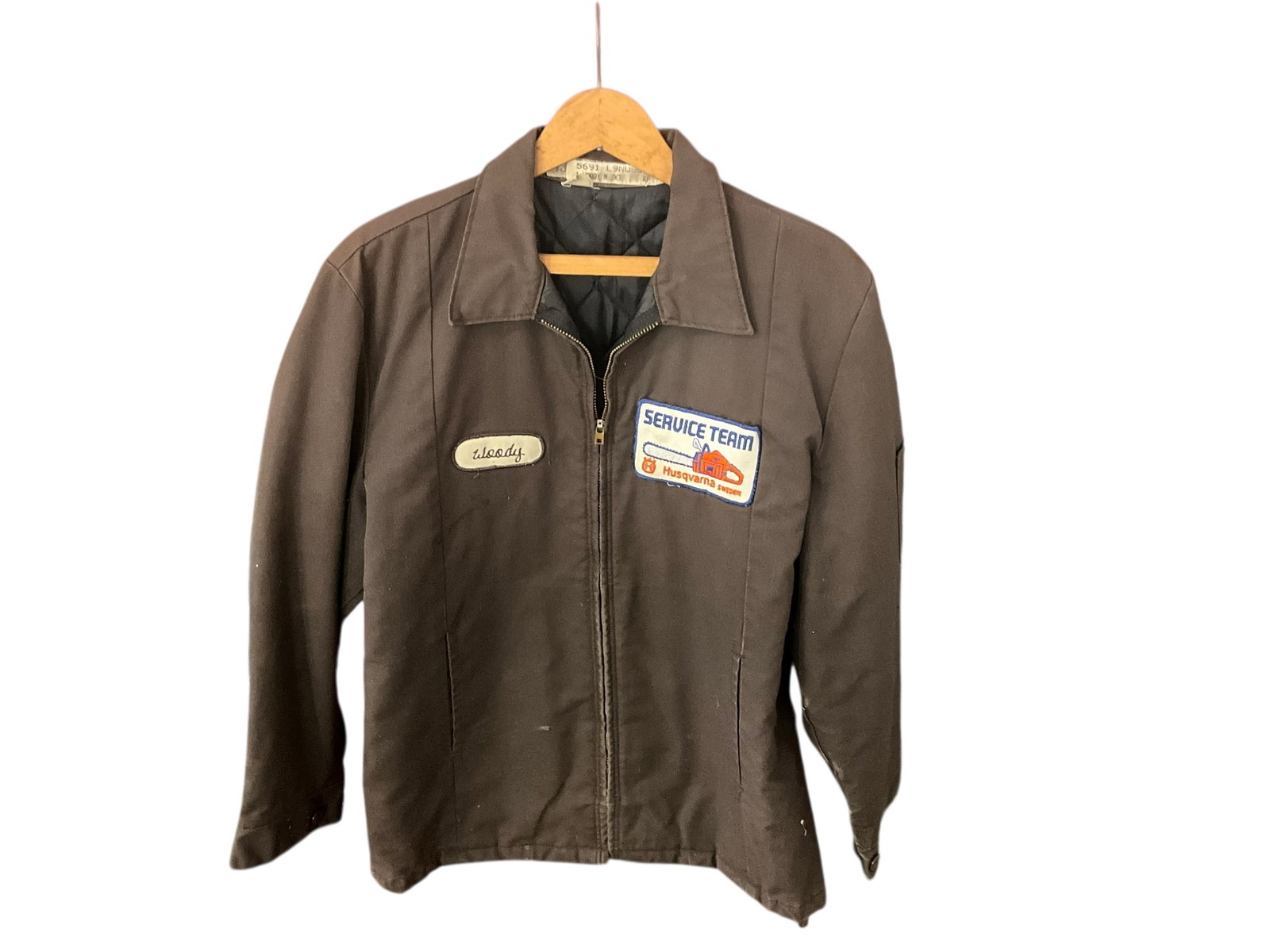 Vintage HUSQVARNA SERVICE TEAM Original Work Jacket WOODY: Original service team jacket. Tech’s name was WOODY. Heavy material. A few torn spots inside from age. Size medium regular. See photos.