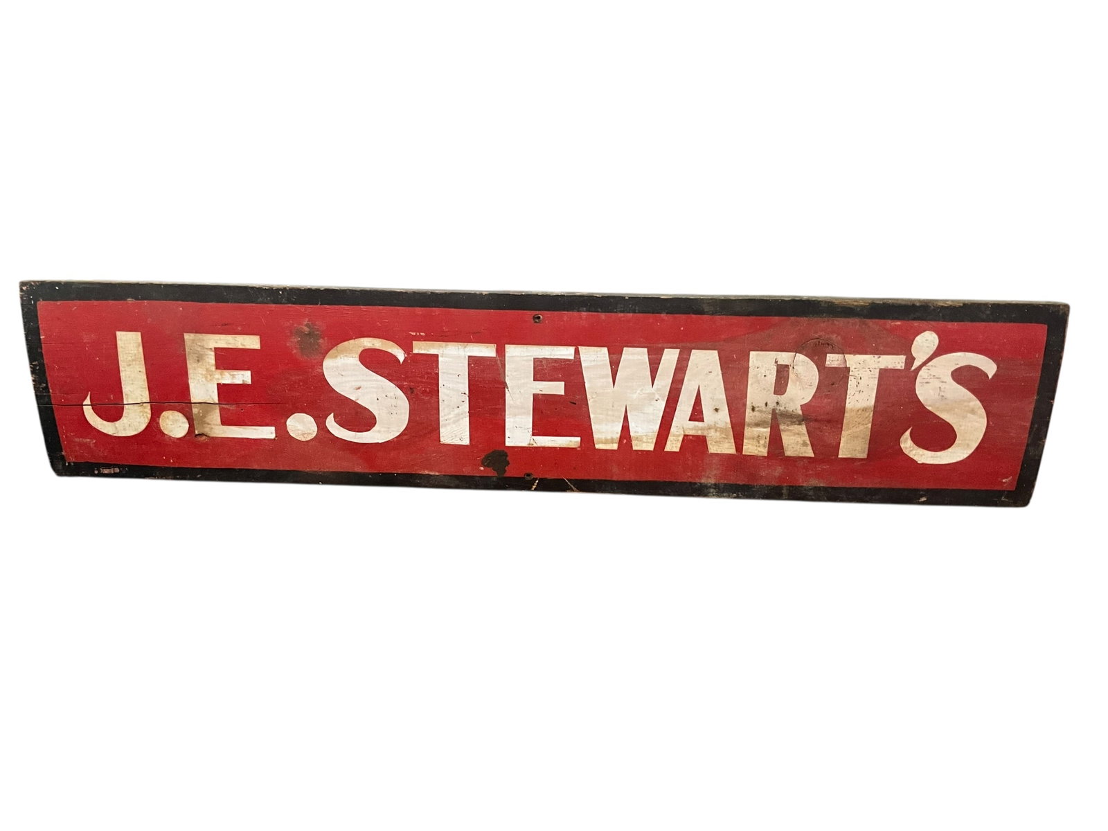 Vintage Wooden J.E. Stewarts Trade Sign: Used condition. Painted sign on wood. 36 x 7 1/2 inches. 3/4 inches thick.