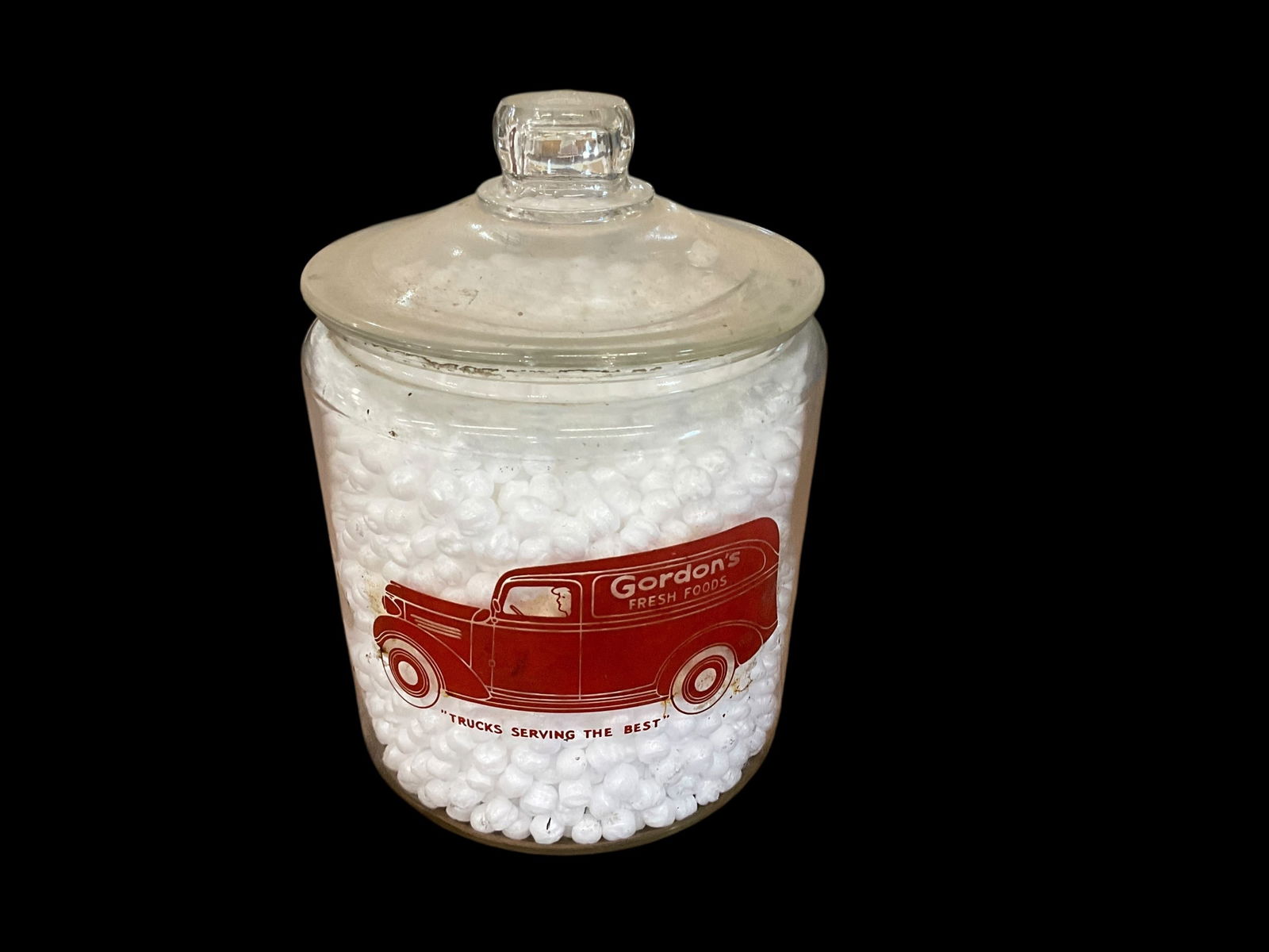 GORDONS Glass Jar With Lid: Used condition. Minor chips around inside lip. Needs cleaning. Measures 10 inches tall x 7 inches wide. See photos.