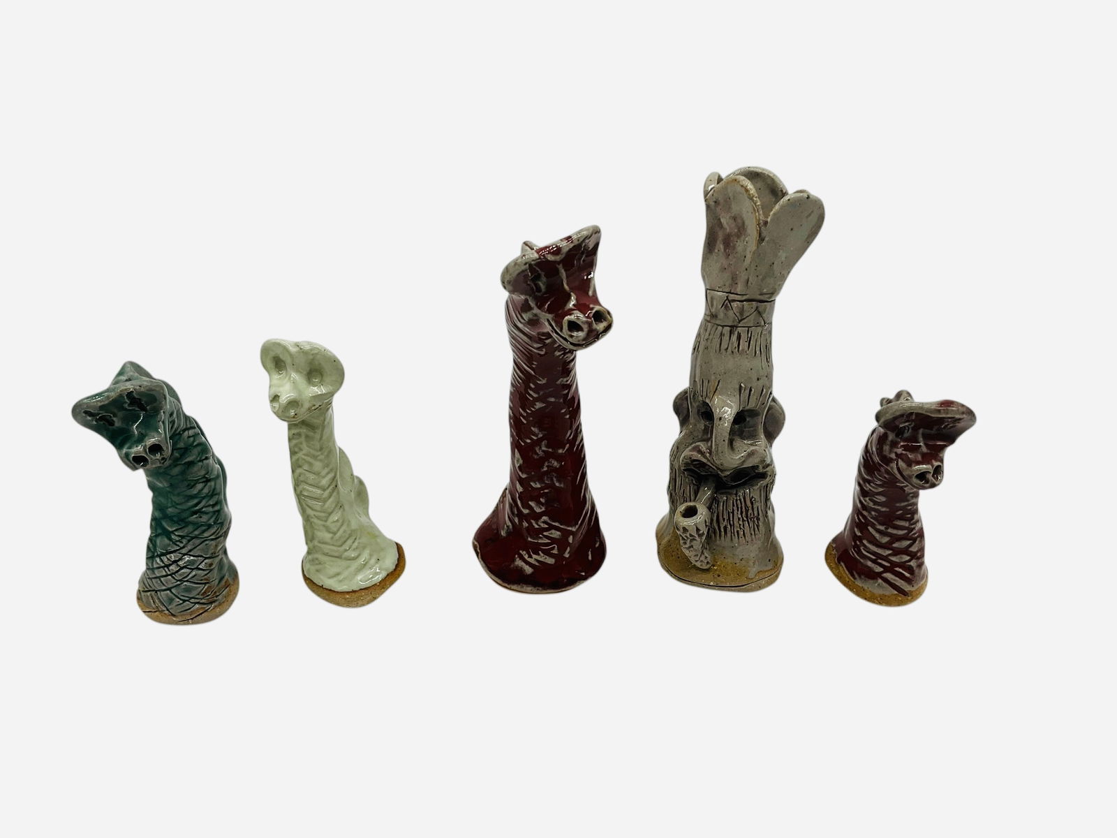 Five Works - Dennis Pitter - Pitter the Potter - North Carolina: Five small pieces total. All in mint condition and signed. Paperwork included for face jug. Four Sea Creatures and One Soco "Gappees" face jug. Paperwork included. Largest piece stands 5 inches tall.