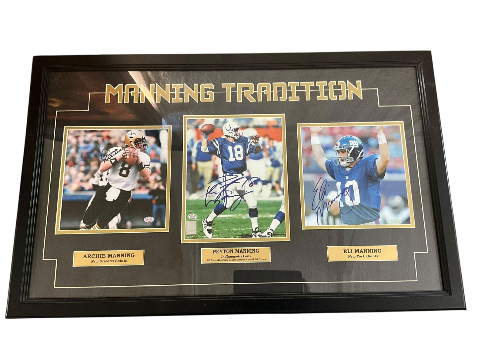 Framed Peyton, Eli & Archie Manning Signed Photos: Excellent condition. Matted and framed. 'Manning Traditions' features three signed photos from Archie, Peyton and Eli Manning. Archie and Peyton photographs come with Stacks of Plaques COA's. Eli