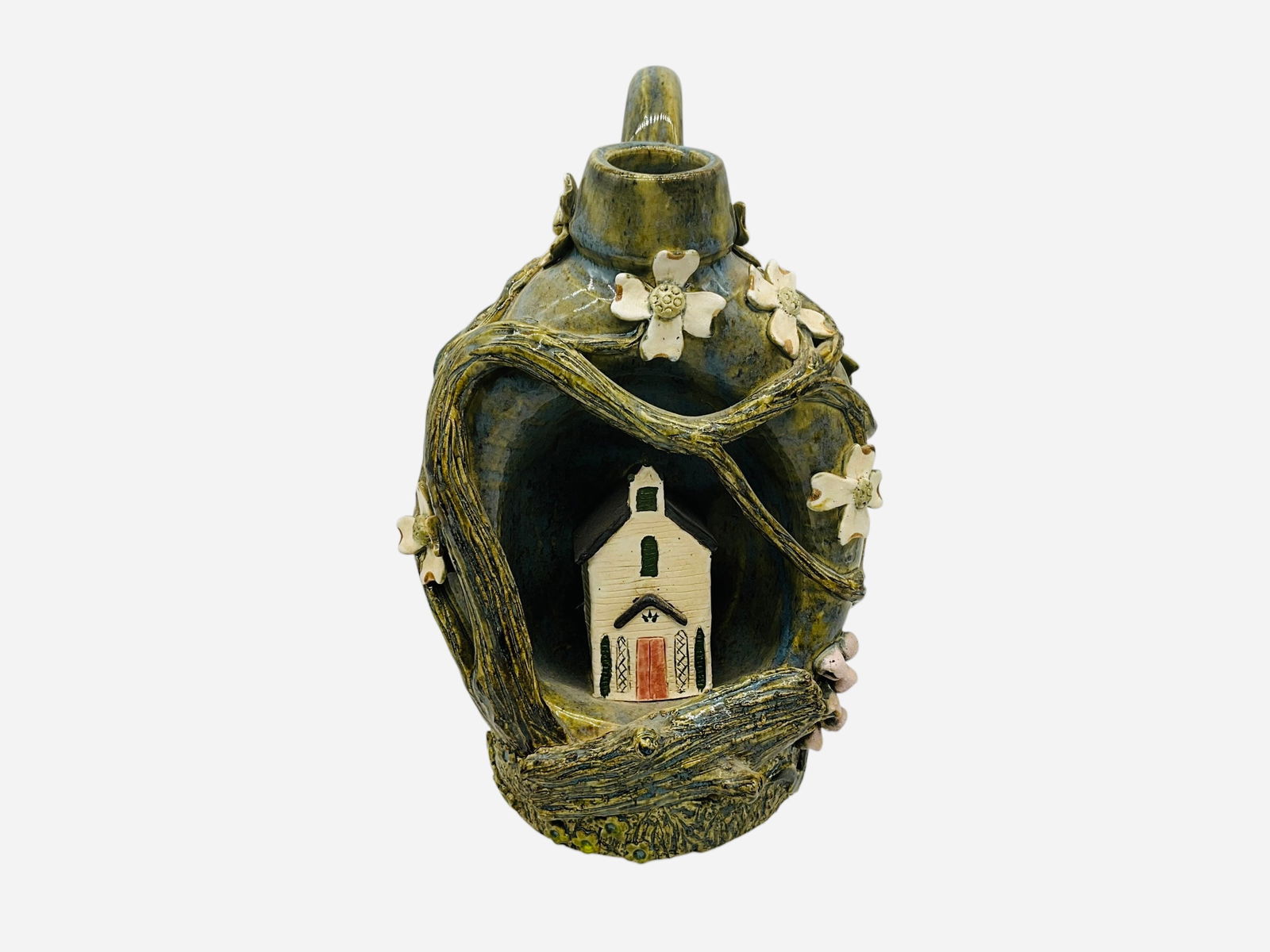 Lin Craven Church Jug w/ Excellent Floral Decoration: Mint condition. An excellent caved jug with church figural. Surrounding the church are excellent tree branches and dogwood flowers. Signed and dated 2009 on bottom. Measures 10.5"H x 7"L x 6.5"W.