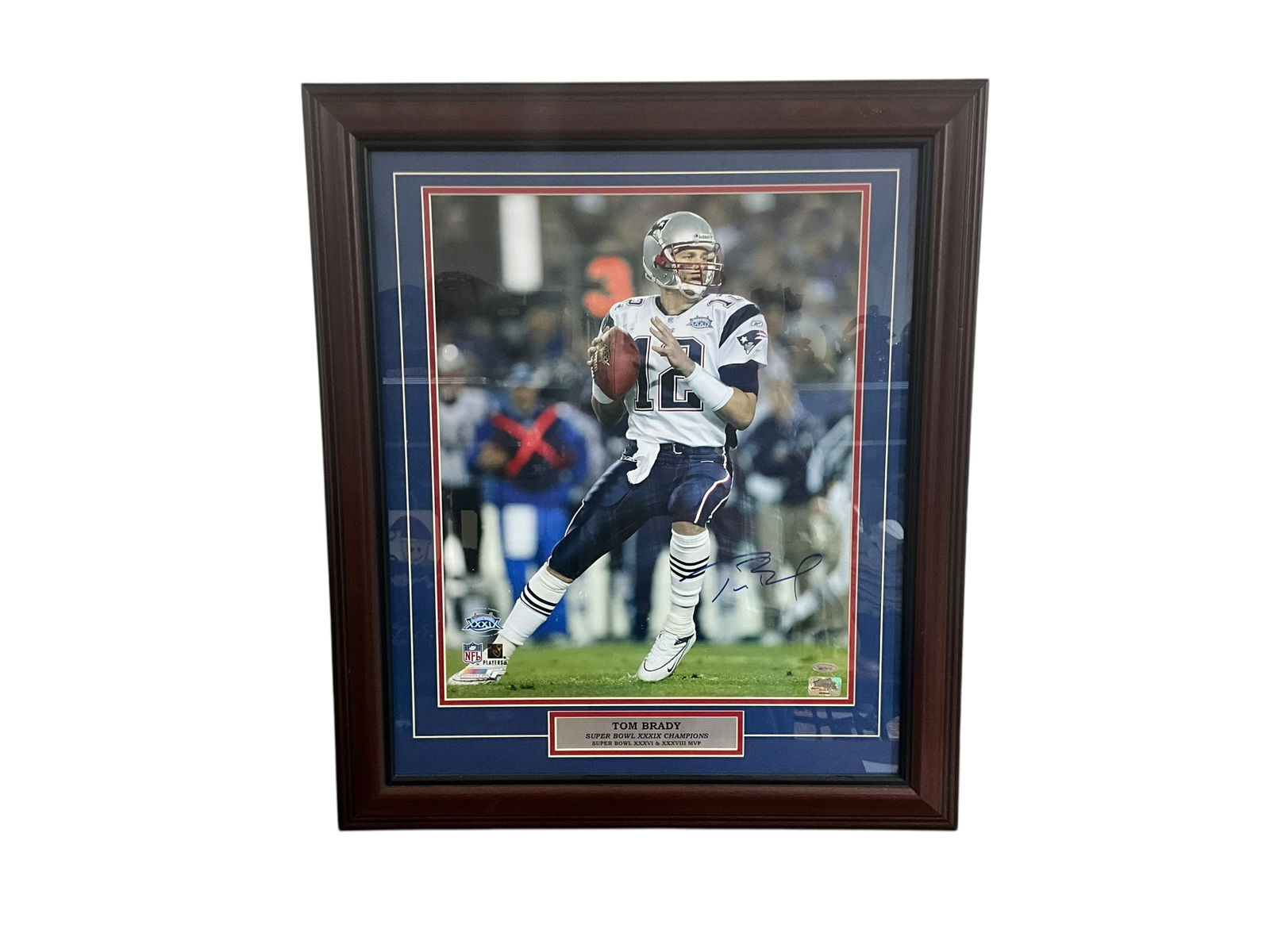 Tom Brady TriStar Large Autographed Super Bowl Photo: An excellent Super Bowl XXXIX photo autographed by Tom Brady. TriStar Productions sticker and COA included. You can also find the certificate online. Cert states this was autographed on April 17,