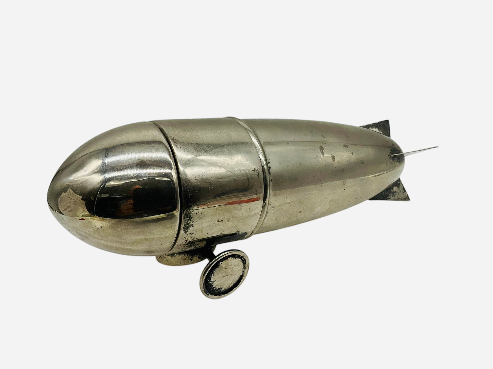 Art Deco Silverplate Zeppelin Cocktail Shaker: Overall good condition with typical age related handling wear. Break down into three sections. No makers mark. Total measurements are 12.5"L x 3.5"W x 4.5"H.