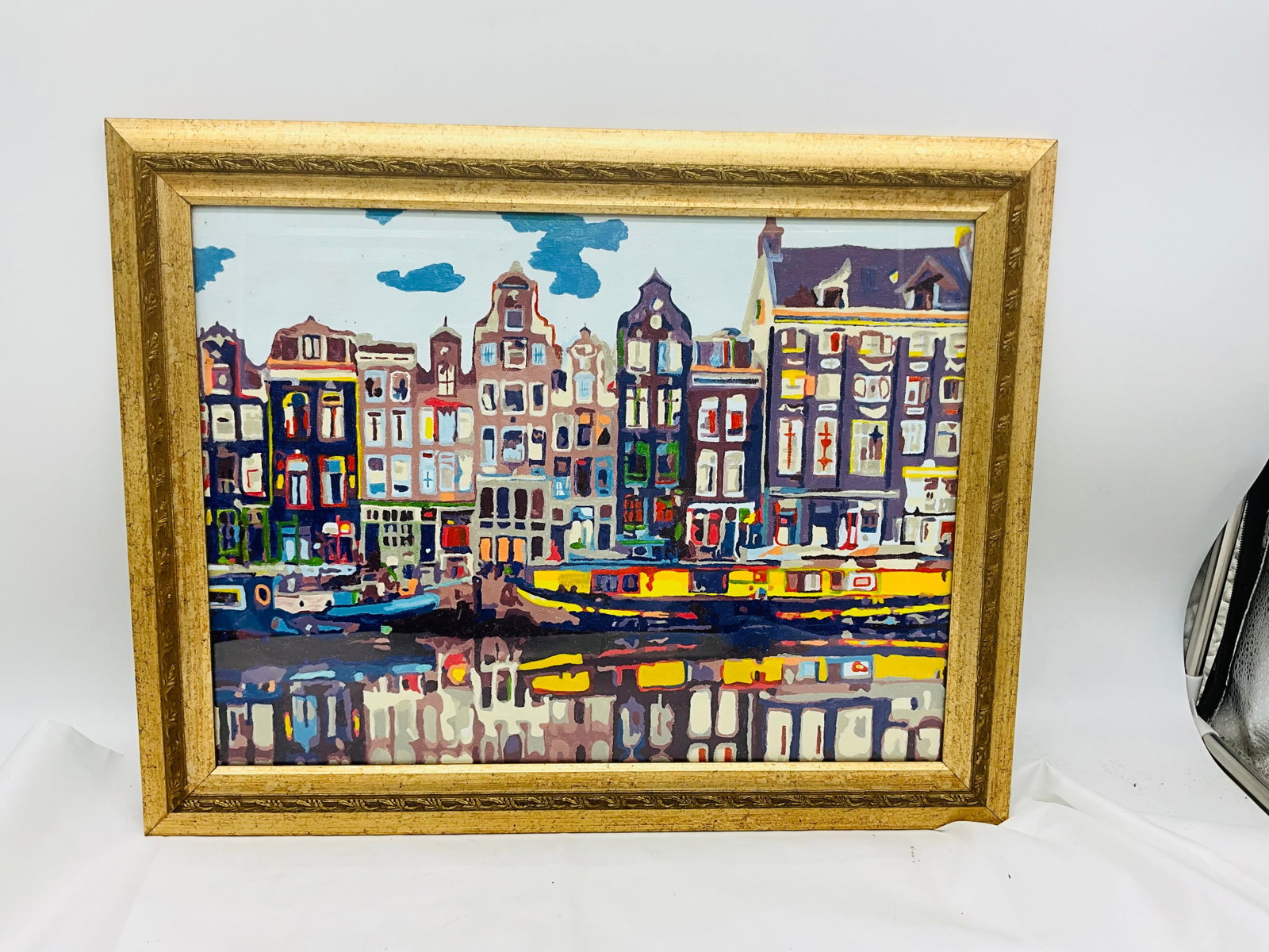 Houses of Amsterdam Oil on Canvas: Houses of Amsterdam oil painting on canvas. Unsigned. Possible paint by number. Painting is framed and measures 14.75" x 19".