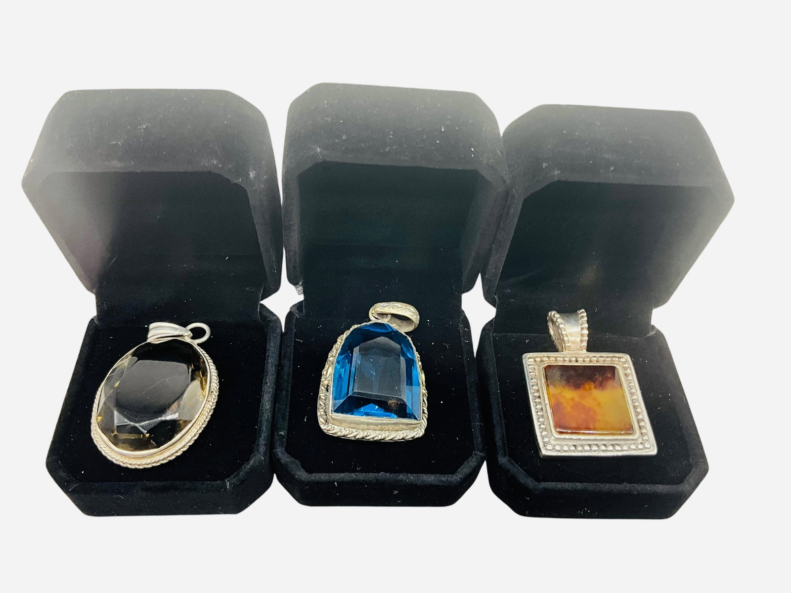 Three Sterling Silver Pendants: Great condition. Each pendant measures approximately 1.25 inches by 1 inch.