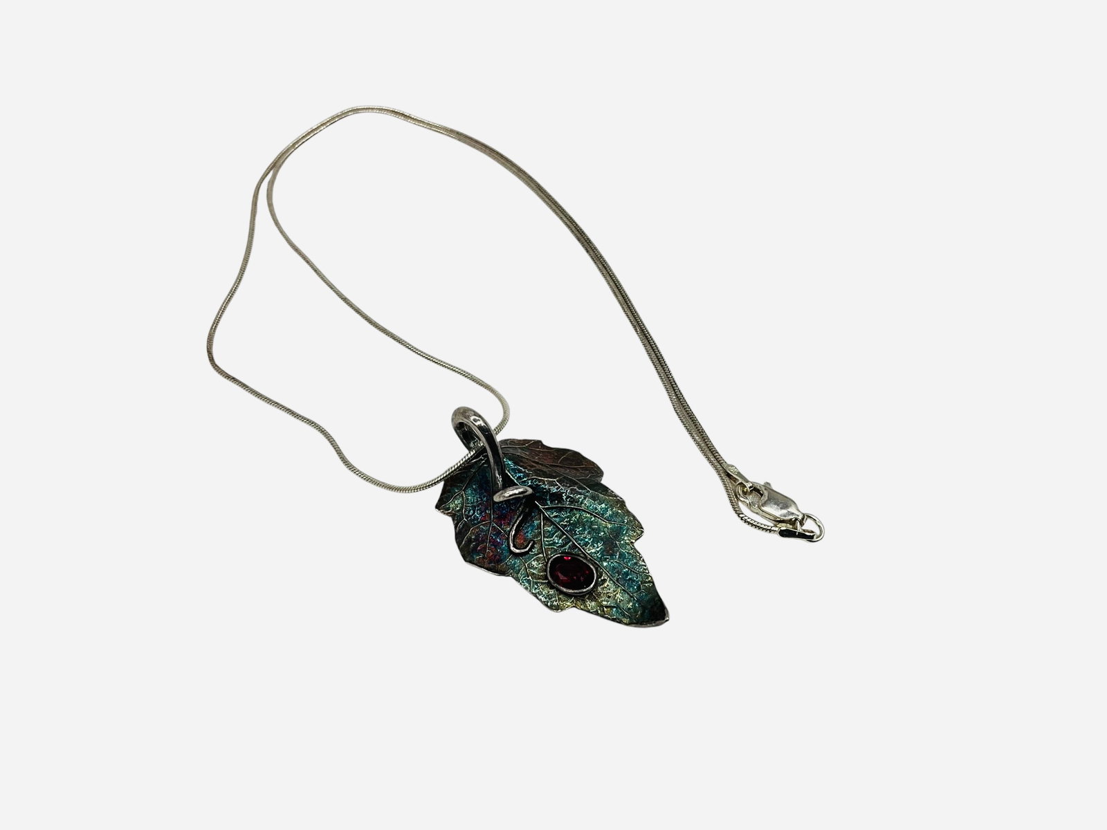Sterling Silver Necklace w/ Leaf Pendant: Excellent condition. Necklace marked 925. Pendant is sterling silver with a great red stone. Makers mark on back. Total weight 9 grams.