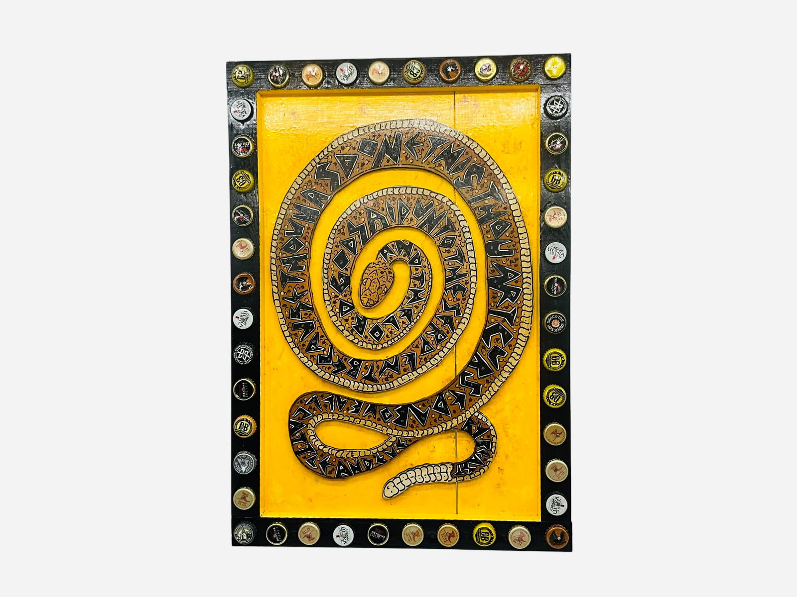 Eric Cunningham Folk Art Rattler Snake on Wood: Excellent condition. Applied painted wooden snake with religious writing on snake body. Applied beer caps on frame. Measures 16 5/8" x 24".