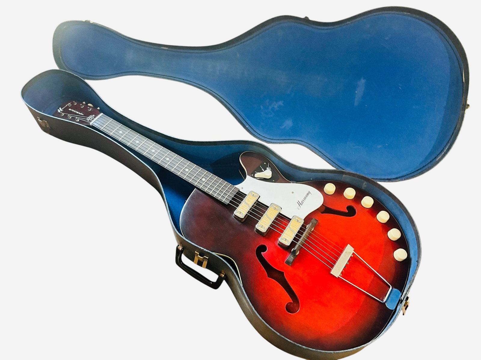 Harmony Rocket H59 Guitar - Sunburst Red: A 1965 Harmony Rocket H59 hollowbody electric guitar, in red sunburst finish. Recently serviced, cleaned and new strings put on. Made in Spring of 1965, the H59 features a 24.25 inch scale length