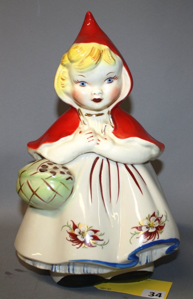 HULL LITTLE RED RIDING HOOD COOKIE JAR: HULL POTTERY LITTLE RED RIDING HOOD COOKIE JAR, WITH POINSETTIA DESIGN, CHIP UNDER CJ LID ON DRAPE OF CAPE, LID IS FROM "TWO POPPY, CLOSED BASKET" JAR