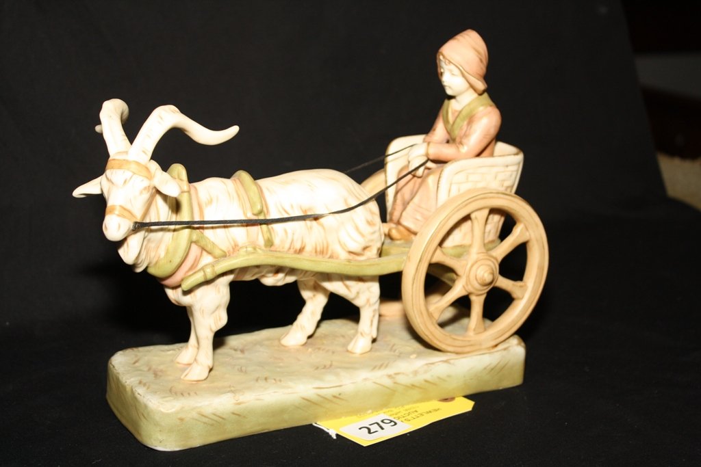 ROYAL DUX FIGURINE: ROYAL DUX FIGURINE, GIRL RIDING IN CART PULLED BY LONG HORN GOAT, MEASURING 3 1/2" WIDE X 10" LONG AND 8 1/2" TALL, Condition Old Chip Under Carriage at Base, see new photos some minor paint ware, MAR