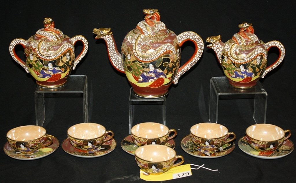 NIPPON TEA SET: EARLY NIPPON TEA SET WITH GOLDEN DRAGON SPOUT (TEAPOT, CREAMER, SUGAR & 6 CUPS & 5 PLATES) CREAMER HAS A CHIP ON THE BOTTOM INSIDE RIM OF BASE, 1 CUP HAS WARE ON THE INSIDE TO THE LUSTER FINISH, 1 SAU