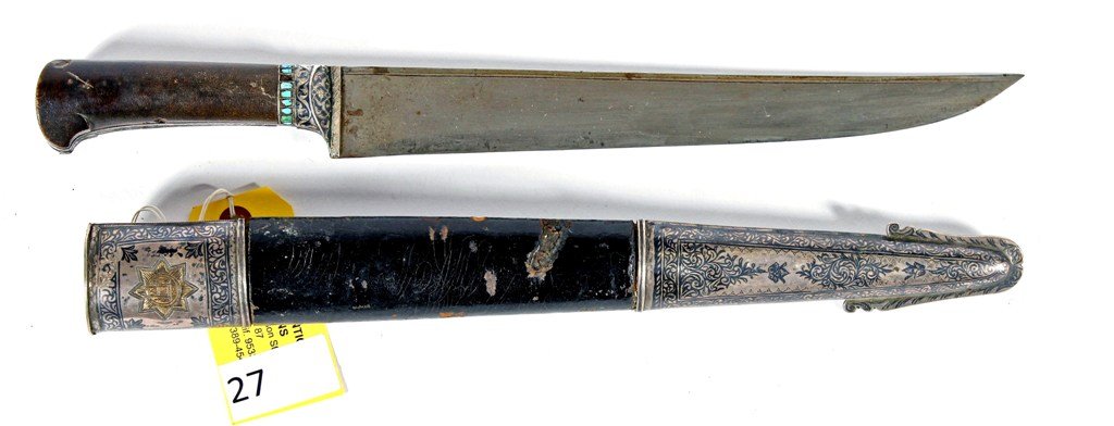 KYBER KNIFE: KYBER KNIFE (SILVER MOUNTED WITH STAR) BLADE LENGTH IS 11 1/2'' AND OVERALL LENGTH IS 19''. CONDITION IS FAIRLY GOOD, DINGS IN LEATHER CASING, TURQOUISE STONES MISSING ONE SIDE OF HANDLE