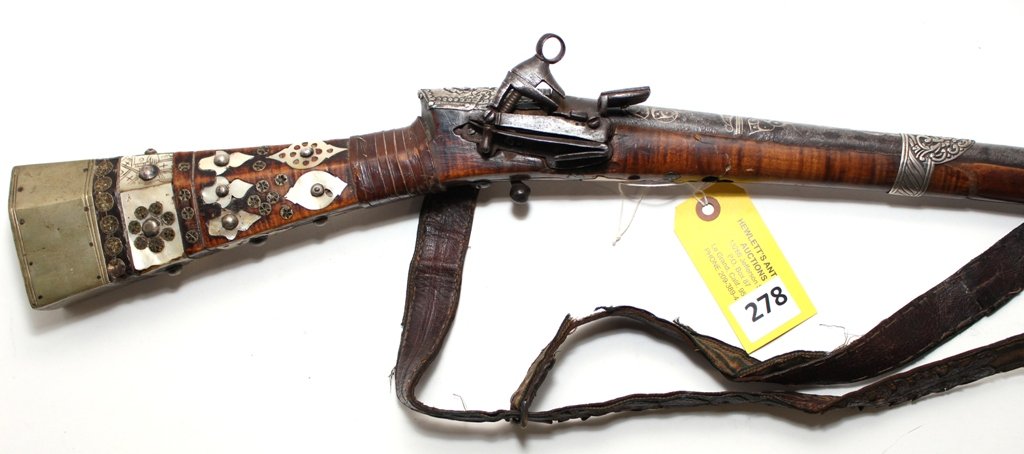 OTTOMAN SISANA CARBINE: EARLY FLINTLOCK OTTOMAN SISANA CARBINE, SILVER INLAY ON DAMASCUS BARREL. MOTHER OF PEARL & SILVER DECORATED. ORNATE BARREL BANDS. FOREARM BROKEN & REGLUED. A FEW BLEMISHES BUT NICE OVERALL
