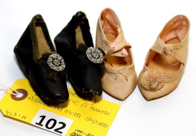 DOLL SHOES: LOTTED 2 PAIR OF DOLL SHOES;PINK FABRIC 1 ROSETTE MISSING & BLACK OIL CLOTH SLIP-ONS