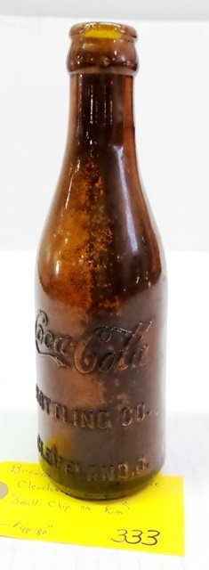 BROWN COCA COLA BOTTLE: BROWN COCA COLA BOTTLE CLEVELAND, OHIO - SMALL CHIP ON RIM