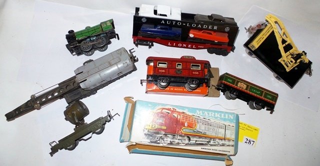 9 ASST MAKES OF TRAIN CAR AND MARKLIN ENGINE: LOT OF 9 ASST. MAKES OF TRAIN CAR AND MARKLIN ENGINE: (1)HORNBY WIND UP 0-4-0 (1)LIONEL 2460 GREY CRANE (1)MARX SEARCH LIGHT CAR (1)MARKLIN SANTA FE ENGINE (5)MISC CARS - FAIR CONDITION.