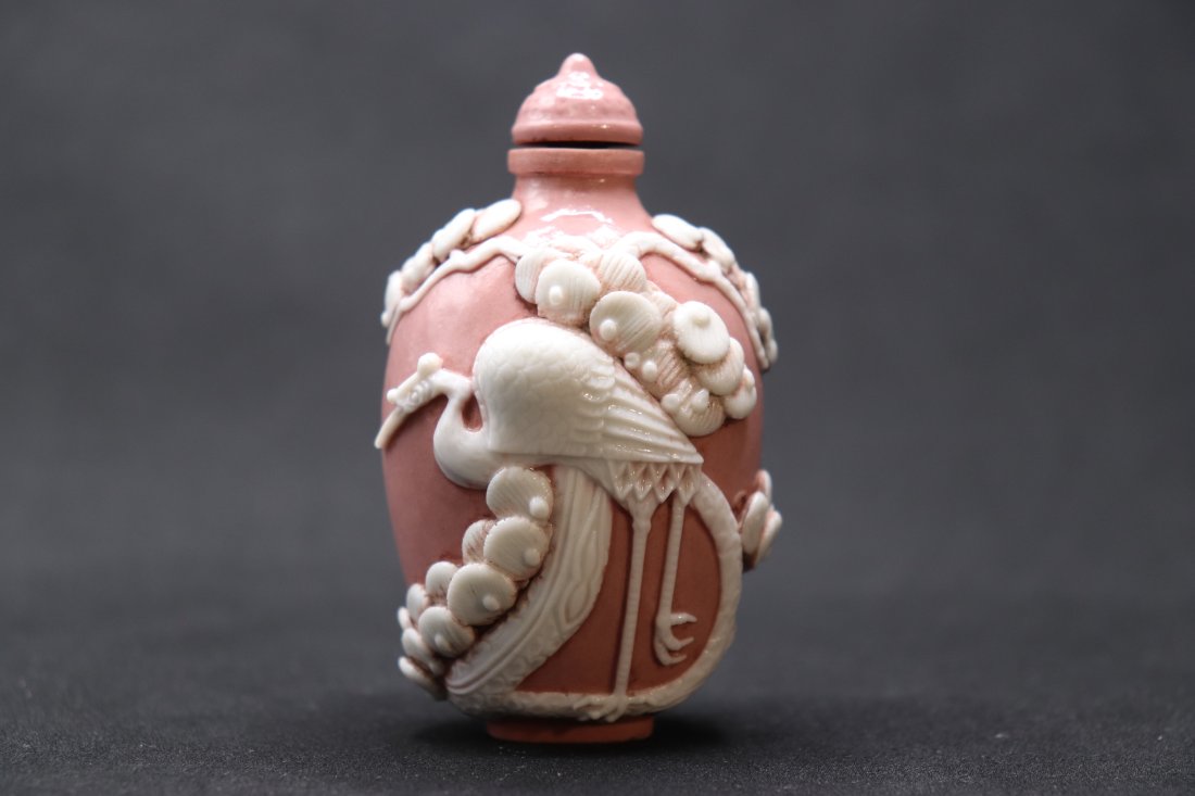 A Daoguang nian four-character seal script pink porcelain stacked pine and crane snuff bottle (1 of 7)
