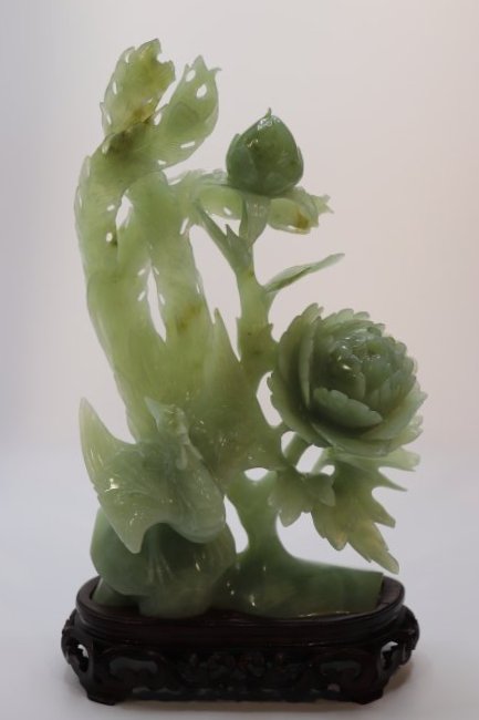 A carved Xiu Jade phoenix and flower with wooden base. (1 of 4)
