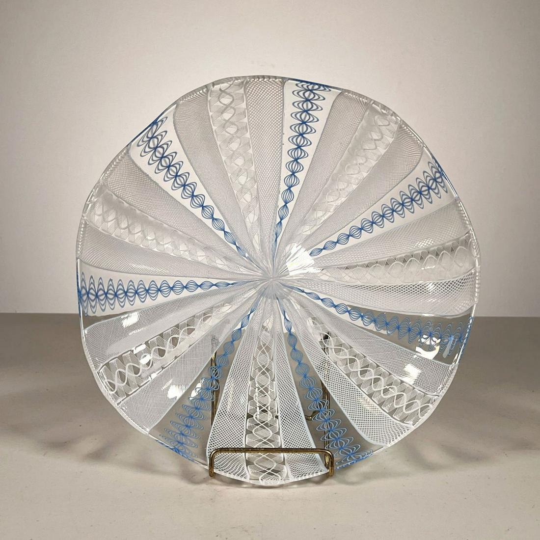 ART GLASS PLATE: Plate has blue & white lacing design on clear. Blown glass with polished pontil. - dia. 9.5 in. Inventory Code: 1K-458 Provenance: Part of over six-hundred Items consigned from an important Millwood, 