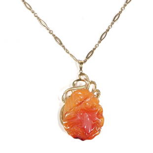 CHINESE AGATE CARVED FROG PENDANT NECKLACE ON GOLD CHAIN: Designed as a finely carved frog upon a leaf beside a flower, the reverse carved in complement, mounted in an openwork 14k gold surround (h. 2 x w. 1.625 in., 32.7g, pendant )and suspended from a 14k